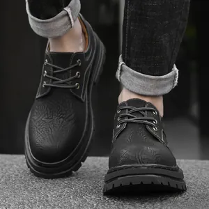 Men's black low-top leather boots with embossed texture and thick anti-slip soles