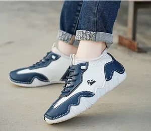 Detailed view of the wavy non-slip sole and side logo on blue and white sneakers