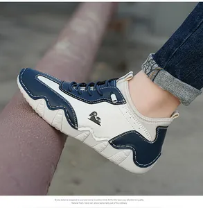 Detailed side view of blue and white casual sneakers featuring a ram logo on soft leather