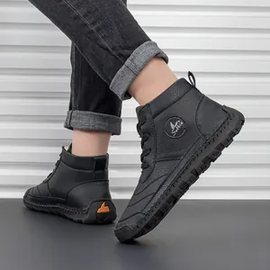 Detail of black leather lace-up martin boots featuring side logo and rugged rubber sole