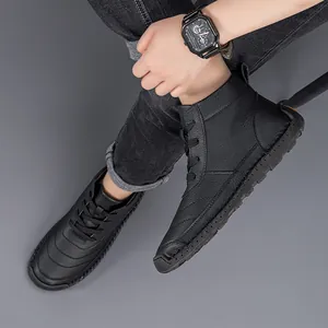 Detailed view of men's black lace-up work boots showing premium lychee leather texture