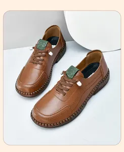 Detailed close-up of brown leather casual shoe with thick stitching and green logo patch