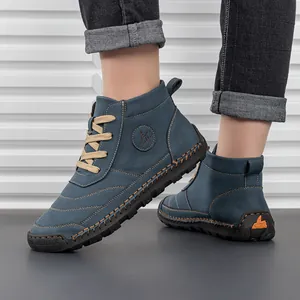 Detail of blue suede high-top boots with stitching and durable beige laces