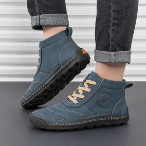 Close-up of blue suede work boots featuring durable lace-up design and contrast stitching