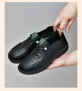 Detail view of black leather casual shoes with non-slip sole and green tongue accent