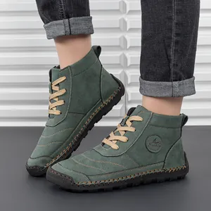 Detail of dark green suede work boots featuring rubber outsole and durable stitching