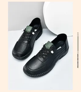 Detail of black leather casual shoes with green tongue patch and durable rubber sole