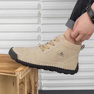 Close-up of khaki suede men's work boots showing textured finish and rubber sole details