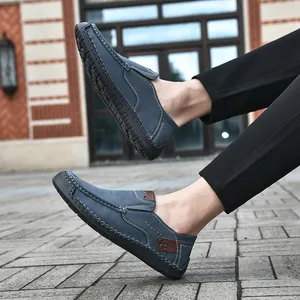 Close-up of blue suede loafers featuring handcrafted stitching and non-slip rubber soles