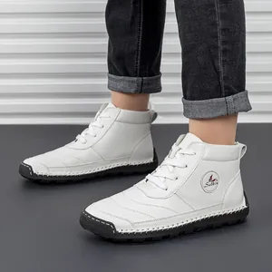 Detail shot of white leather high-top boots with 100% rubber sole and branded logo