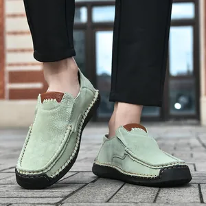 Detail of green suede loafers with contrast hand-stitching and durable rubber sole