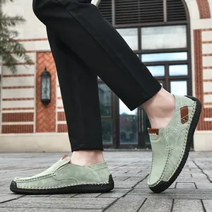 Detail of light green suede loafers with hand-stitched seams and durable rubber sole