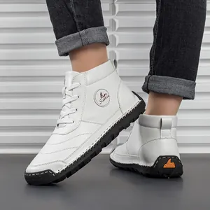 Detail of white leather men's work boots with orange Salkin logo and contrast stitching