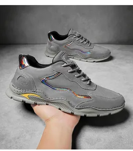 Detail of grey mesh leather sneakers featuring iridescent stripes and yellow heel accents