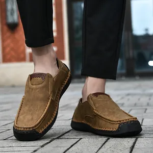 Detail of brown slip-on men loafers with thick rubber soles and hand-stitched seams