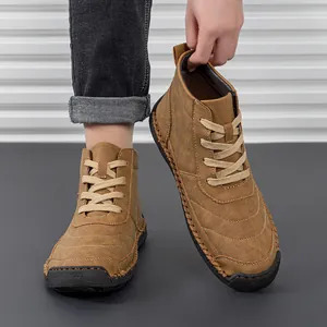 Detail of brown leather boots showing 100% rubber sole and precision stitching