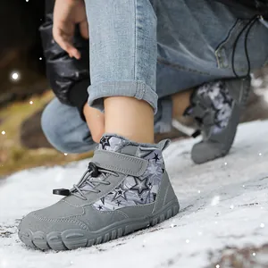 Grey winter barefoot snow boots for kids featuring star patterns and plush lining in snow