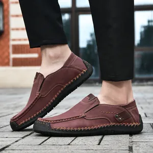 Detail of dark brown leather loafers featuring handmade stitching and rubber sole traction