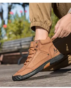 Detail of men brown PU leather ankle boots with hand-stitched seams and Salkin logo