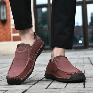 Detail of hand-stitched brown suede loafers with anti-slip rubber soles for men