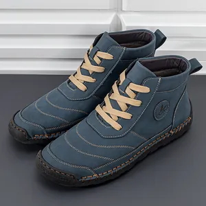 Deep blue suede lace-up men's ankle boots with thick rubber soles and contrast stitching