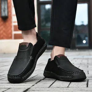 Detail of men's leather loafers with litchi texture and handmade stitching on rubber sole