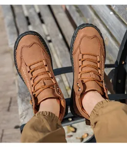 Close-up of brown PU leather men's casual boots with hand-stitched details and rubber toe cap