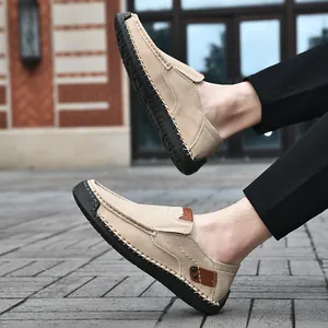 Detail of khaki suede loafers showing hand-stitched side seams and rubber outsole