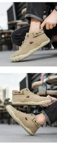 Close-up of khaki suede high-top boots featuring a secure velcro strap and rubber sole