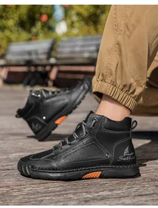 Close-up of black PU leather high-top boot with orange accents and fine stitching details