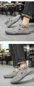 Detail of grey suede high-top outdoor boots with lace-up closure and ankle velcro strap