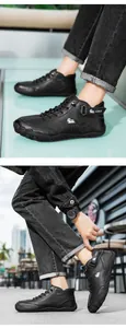 Detail of men's black high-top boots featuring velcro strap and non-slip rubber soles