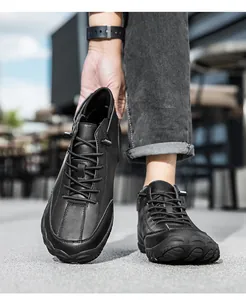 Close-up of black leather outdoor men's boots featuring durable rubber soles and lace-up design