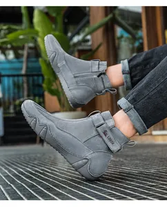 Dettaglio stivaletto in pelle grigia con zip laterale, velcro e suola in gomma