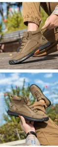 Detail view of khaki PU leather boots with decorative hand stitching and high-top design