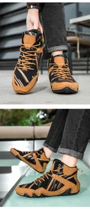 Detail view of brown and black high-top boots with textured synthetic leather and lace-up design