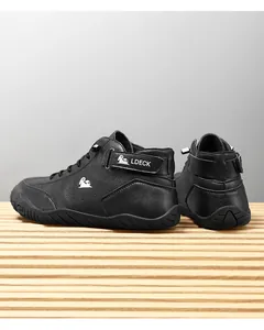 Detail of black leather casual boots with LDECK logo and non-slip rubber sole
