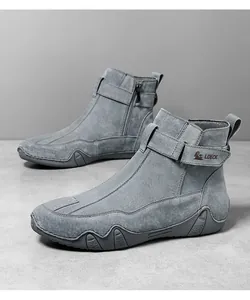 Dettaglio di stivali in pelle grigia con zip laterale in metallo e suola antiscivolo