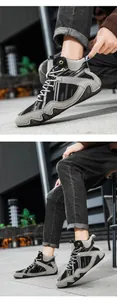 Detail of high-top casual boots featuring grey stitching and textured rubber sole for men