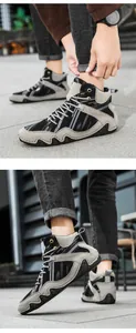 Detail of high-top outdoor boots featuring multi-material stitching and wavy rubber soles