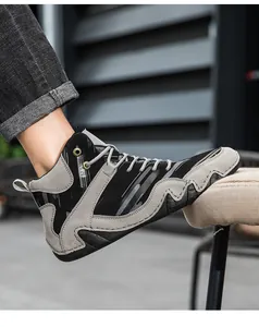 Detail of high-top outdoor boots with striped canvas, suede patches, and wavy rubber soles
