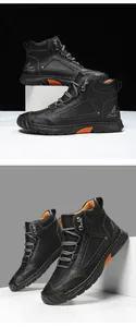 Detail view of black PU leather boots with orange accents and durable metal eyelets
