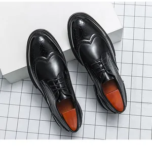 Close-up of black leather brogue shoes with wingtip detailing and classic laces