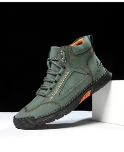 Detail of grey-green PU leather high-top boot featuring orange anti-slip sole inserts