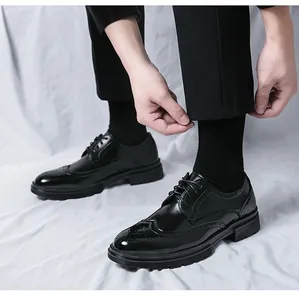 Close-up of men's black Brogue shoes with wingtip perforations and non-slip rubber soles