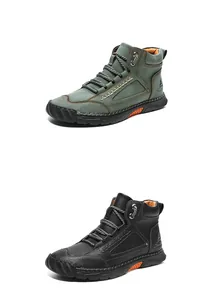 Close-up of high-top PU leather boots with textured finish and orange sole accents