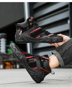 Close-up of black high-top boots with red lines and wave-shaped anti-slip rubber soles