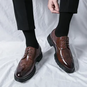 Men's dark brown wingtip brogue oxfords with polished toe and thick rubber sole