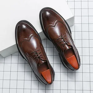Classic brown leather brogue shoes for men with elegant wingtip carved detailing