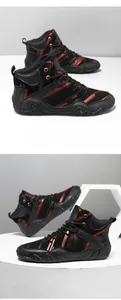 Close-up detail of high-top casual sneakers with red paint brush pattern and black leather